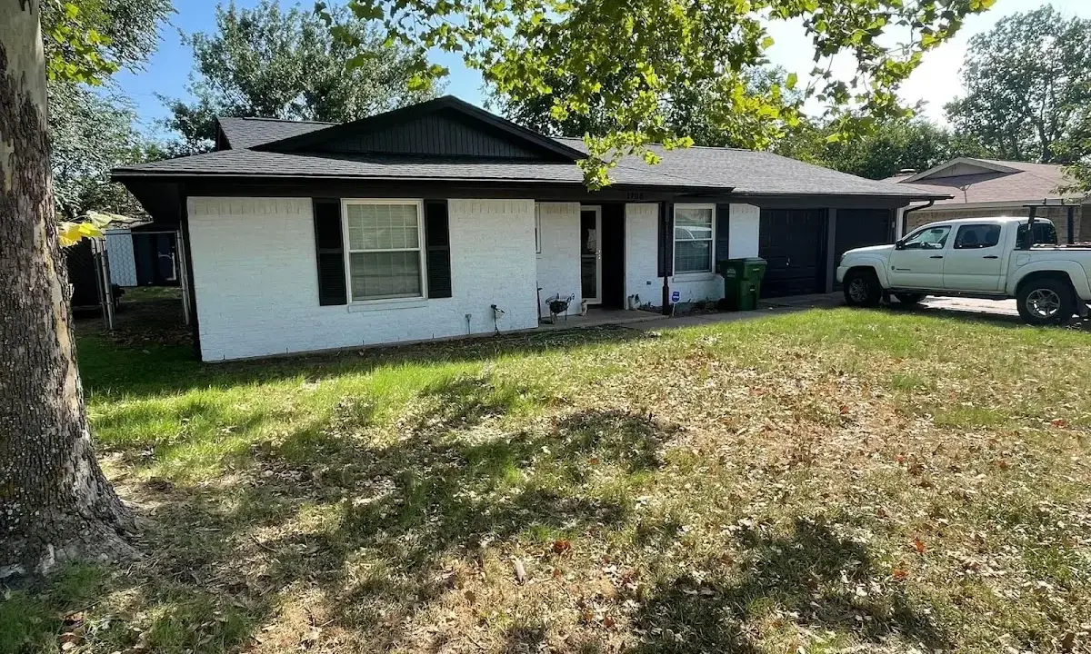 Professional roofing crew working on a residential roof in Fulton
